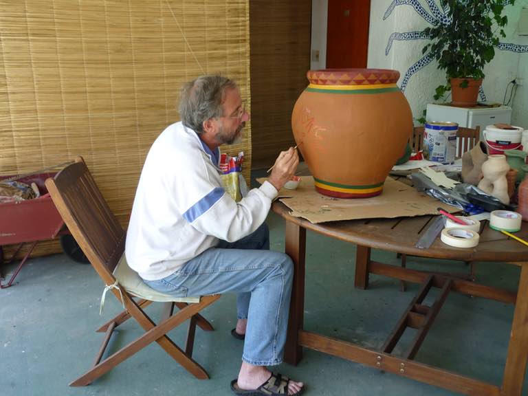 Syd Blackwell painting a flower pot