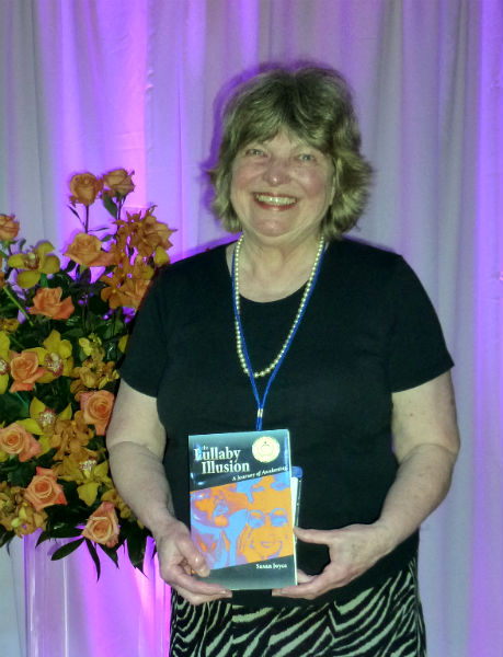 Susan Joyce receives a Gold medal for The Lullaby Illusion.